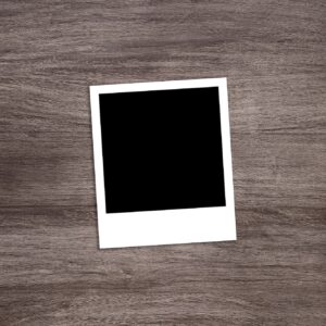 blackened instant photo print template on rustic wooden table