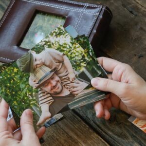 Photo printing, family memories. Woman looks at printed photos for family picture album.